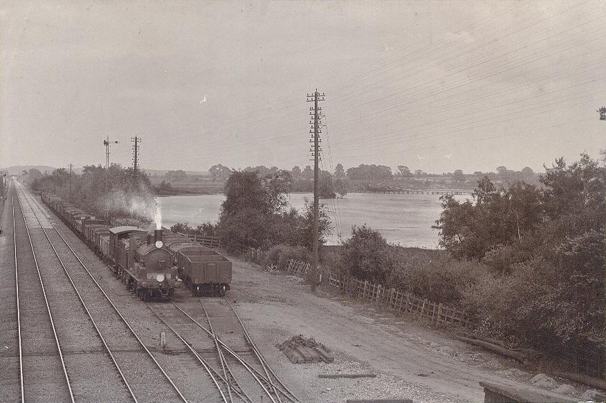 Steam train beside Fleet Pond at Fleet railway station, circa 1900